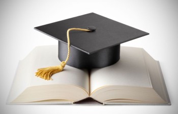 A mortarboard and book demonstrate the success of higher ed recruitment.