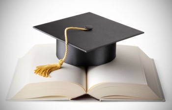 A mortarboard and book demonstrate the success of higher ed recruitment.
